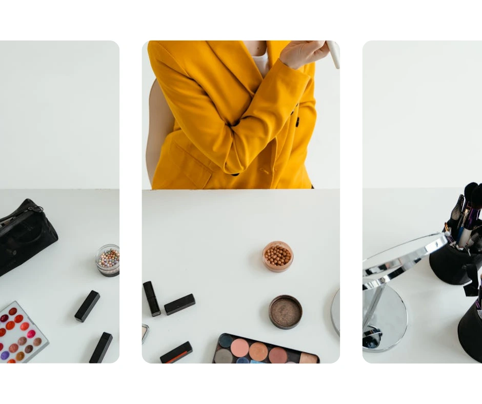 Un'immagine ravvicinata di un tavolo bianco su cui è appoggiato un mucchio di trucco e sul quale una donna in abito giallo sta applicando il trucco